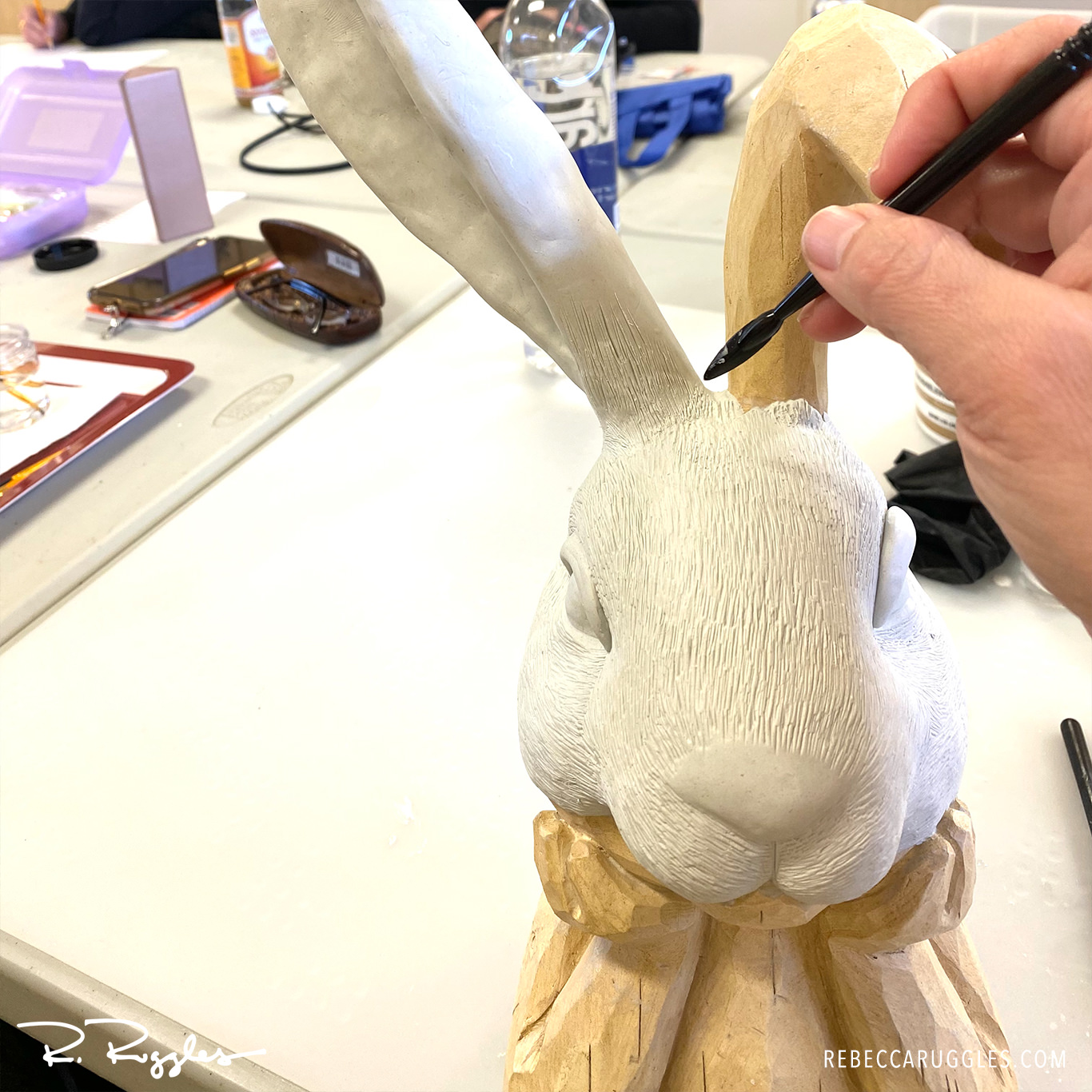 Applying and sculpting Apoxie Sculpt to the bunny statue at art group
