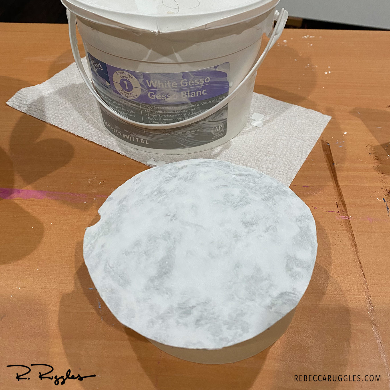 Filling and smoothing concrete paper clay with joint compound and gesso.