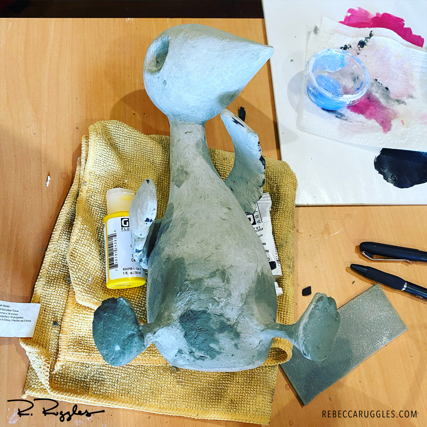 Baby bird sculpture in progress. Sculpting the feet, by artist Rebecca Ruggles.
