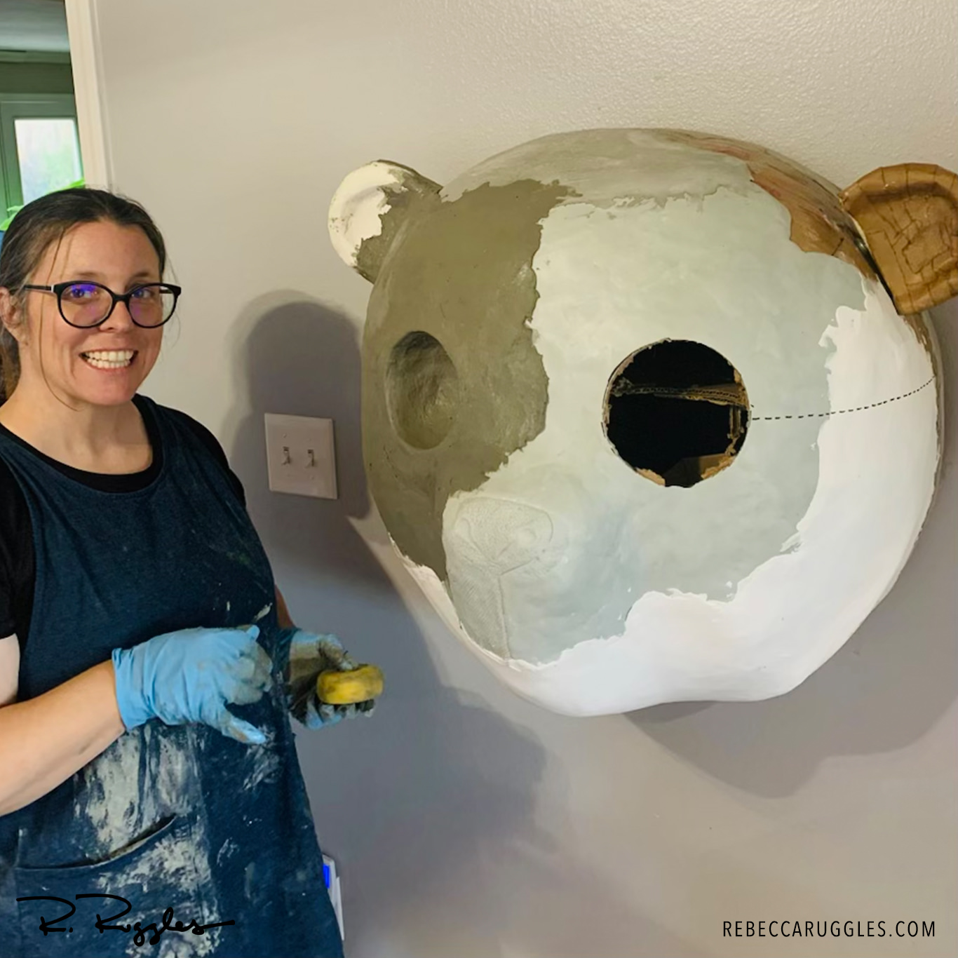 Rebecca Ruggles toweling clay on the panda sculpture.
