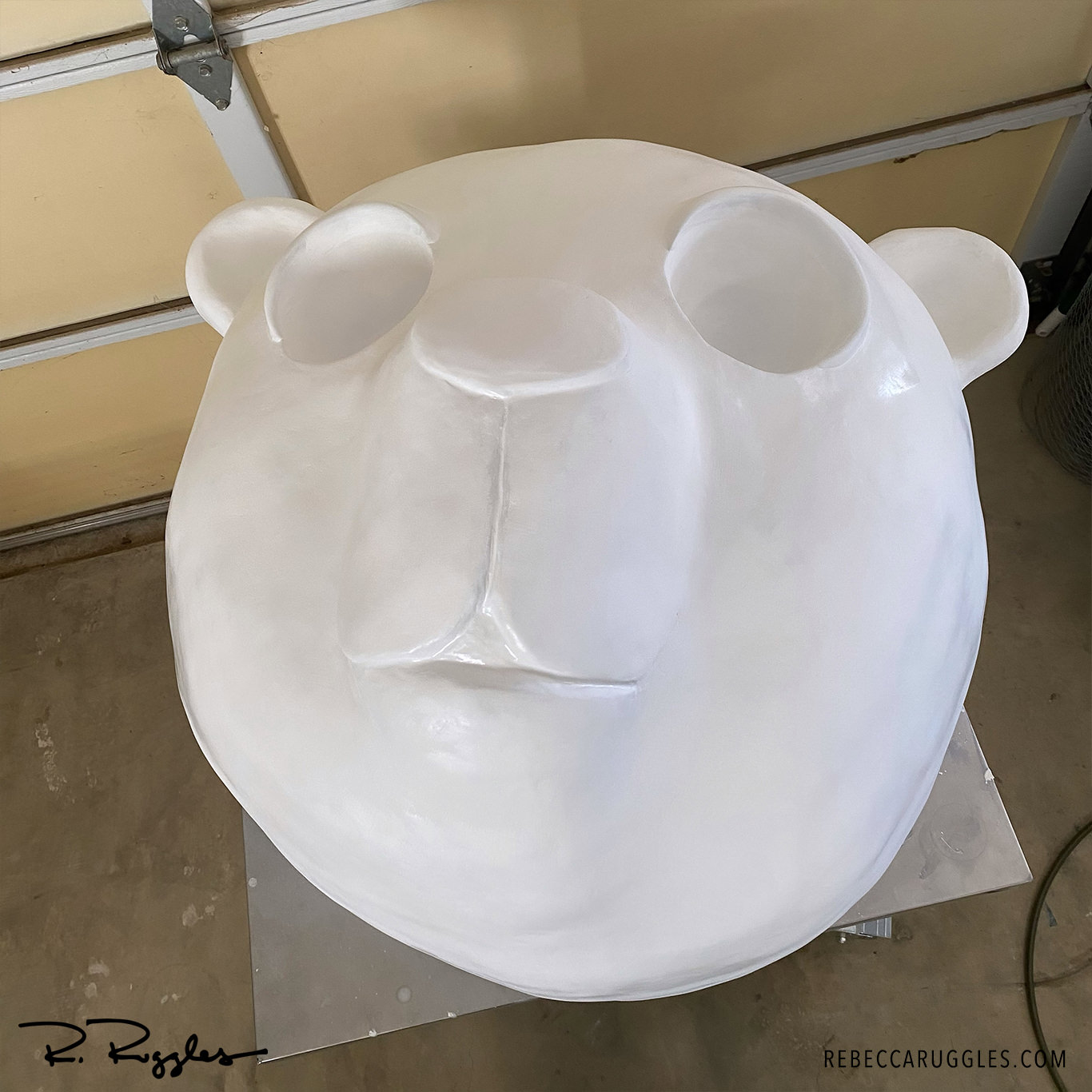 Panda head sculpture sanded and primed with gesso for paint.