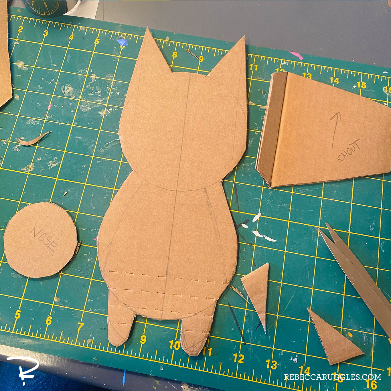 Cutting the cardboard profile pieces referencing a sketch.